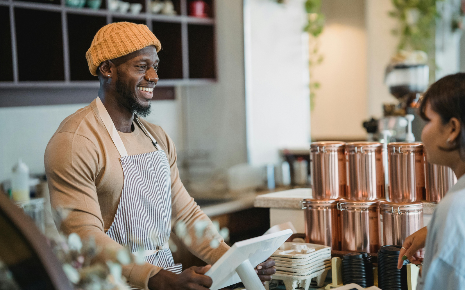 Australian cafe staff recognising a regular customer, showing how familiarity and personal service drive customer retention in Australia