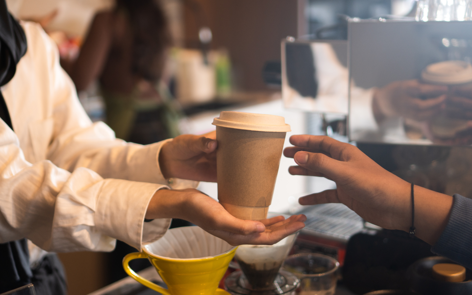 Suburban cafe staff rewarding a regular customer through a loyalty program