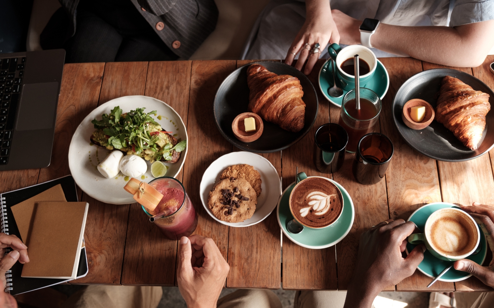 Coffee shop customer purchasing coffee and pastry, demonstrating increased spend through loyalty program