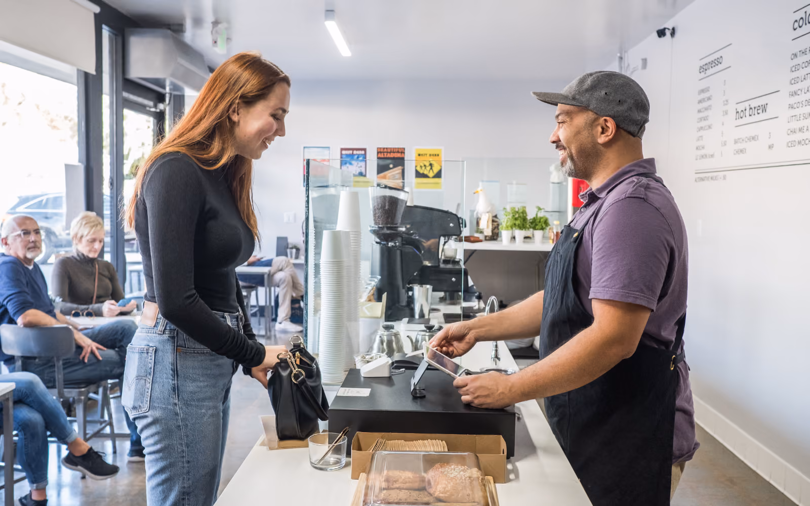 woman getting her benefits out of a loyalty program and the cafe owner increasing customer retention
