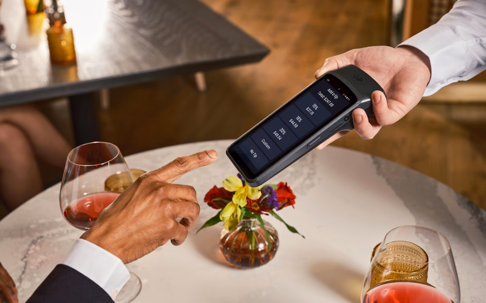 Customer using a digital restaurant loyalty program app at a restaurant counter to check in and earn rewards