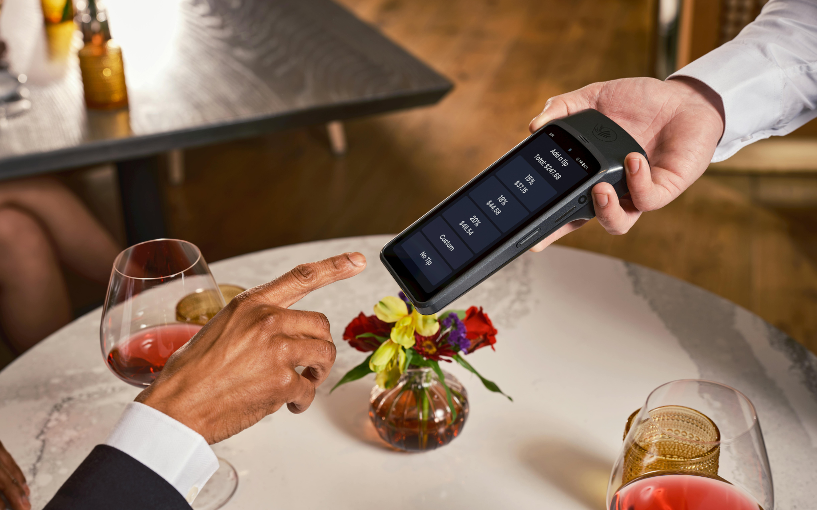 Customer using a digital restaurant loyalty program app at a restaurant counter to check in and earn rewards