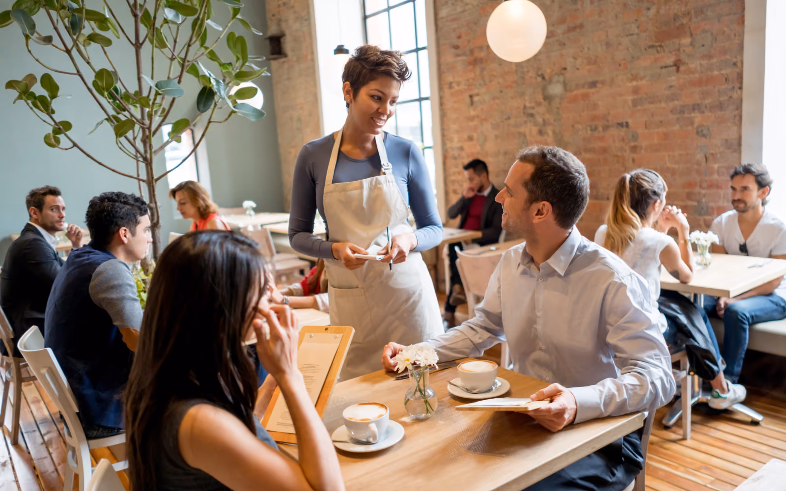 Customer using a digital restaurant loyalty program on their phone to check in and earn rewards at a casual dining restaurant