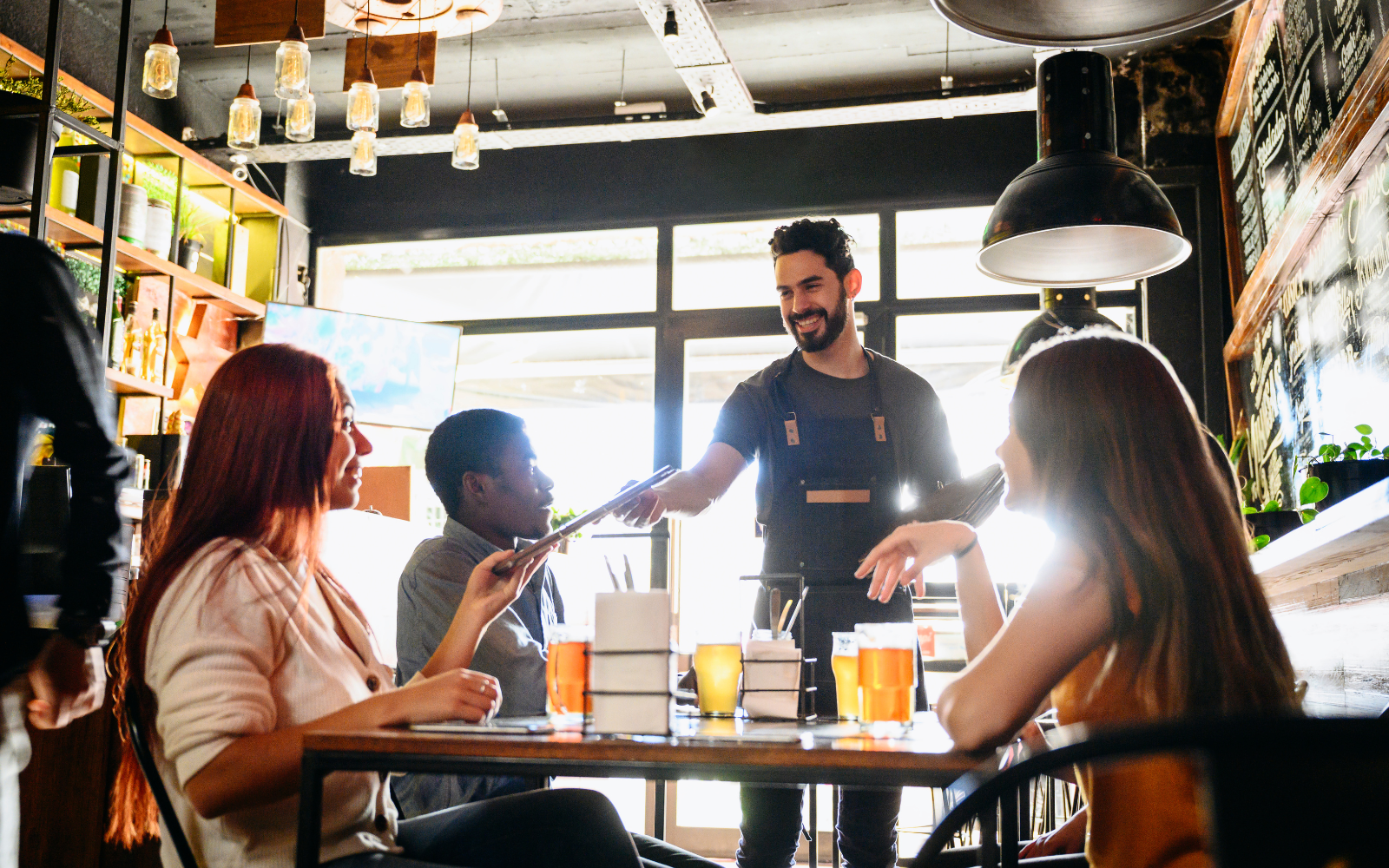 Restaurant server redeeming a digital loyalty reward at the table