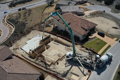Aerial Photo of one of Custom Luxury Home projects where we utilized a boom truck to pour a retaining wall with precision.