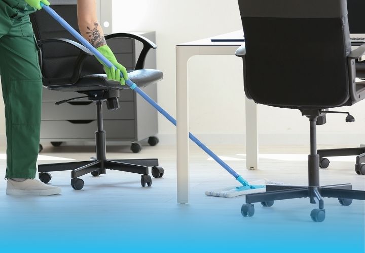 mopping underneath table in an office setting