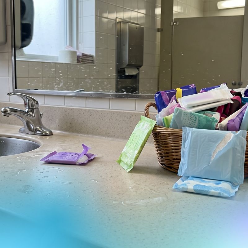 a basket overflowing with menstrual pads, some spilling over, and others slightly opened. 