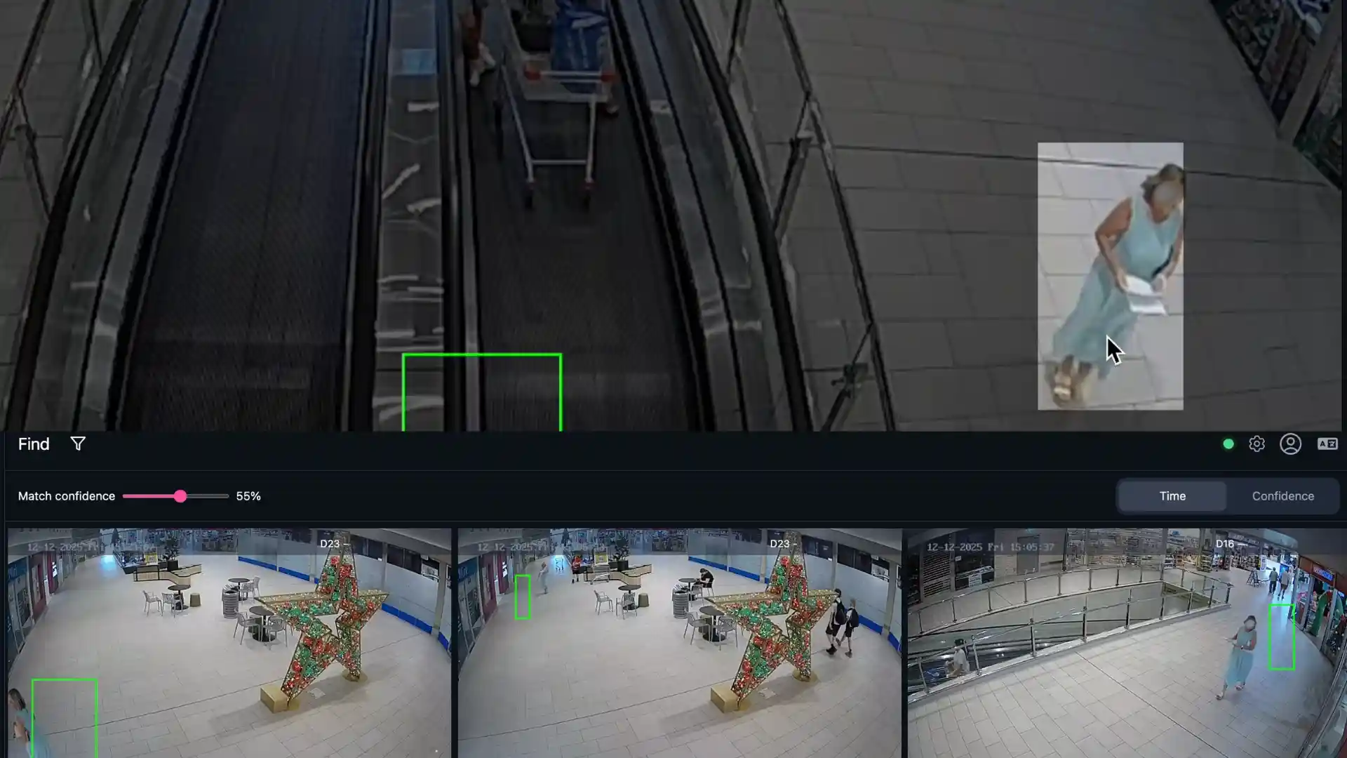 Security camera interface showing mall escalators and hall with star decoration and multiple people.