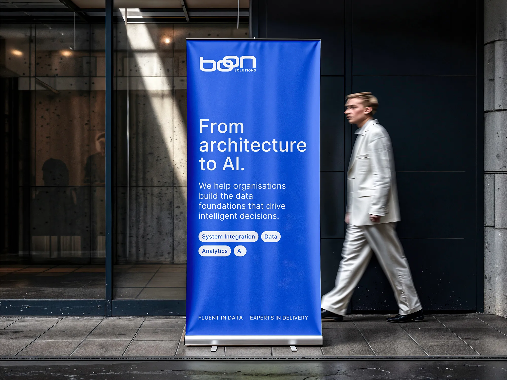 Blue Boon Solutions pull-up banner promoting data and AI consulting outside an office building.
