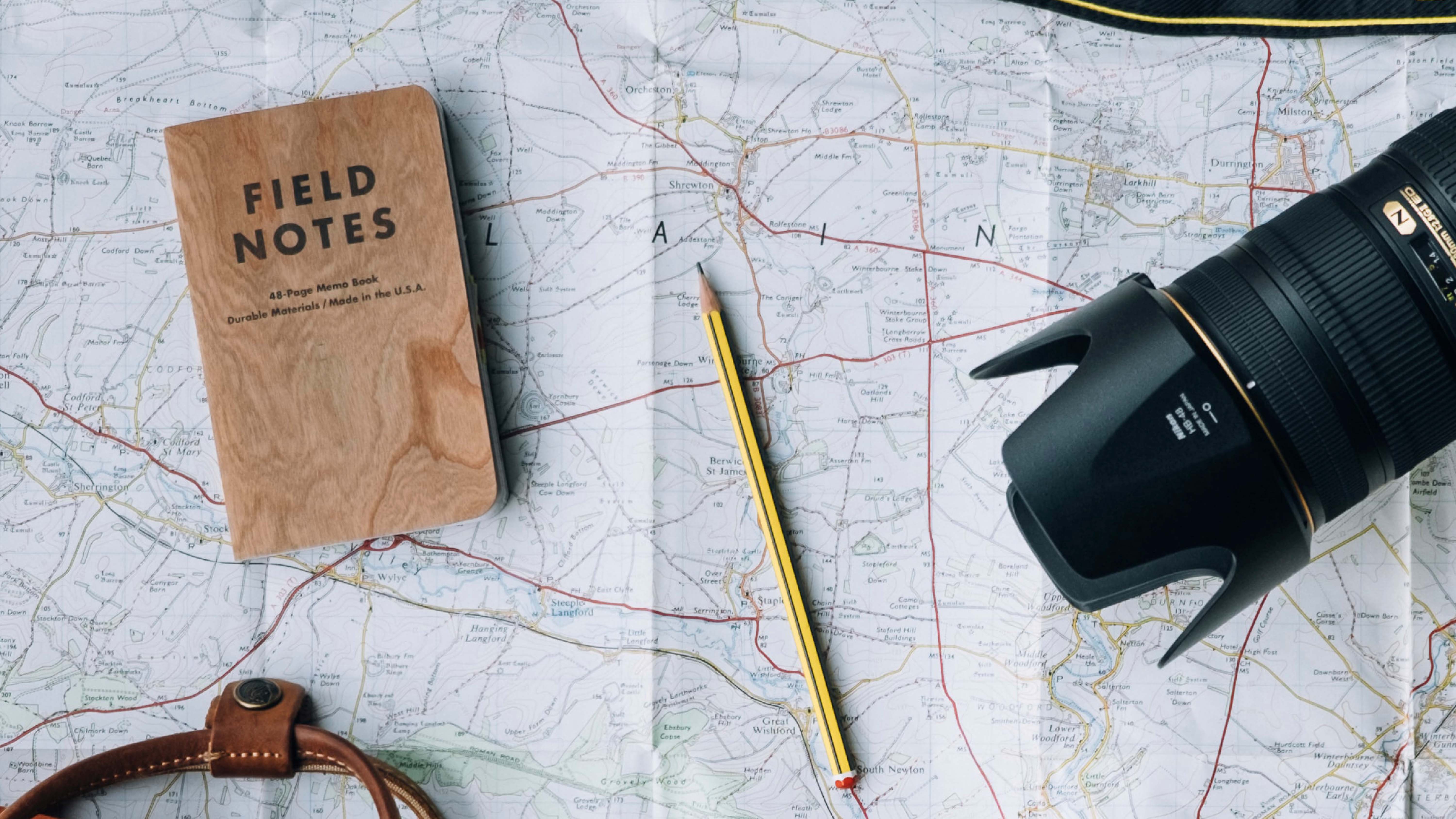 A map with a notebook and a pencil
