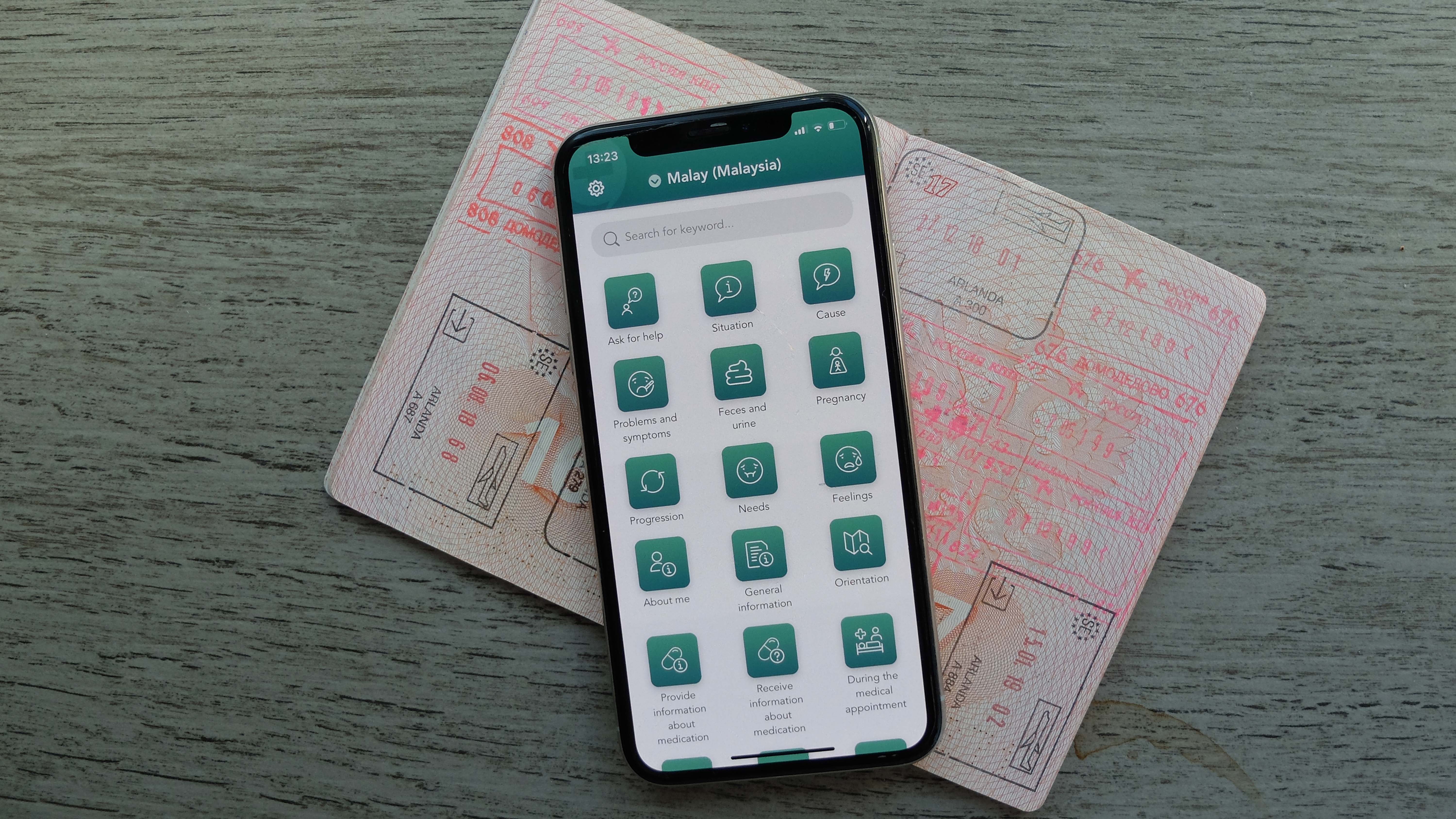 The app Care to Translate on a smartphone and a passport