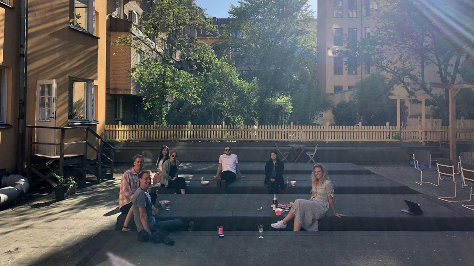 photo of team care to translate sitting outside the office in the sun