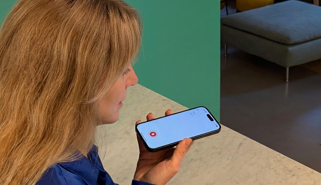 Maja Magnusson speaking into the Care to Translate app on a smartphone