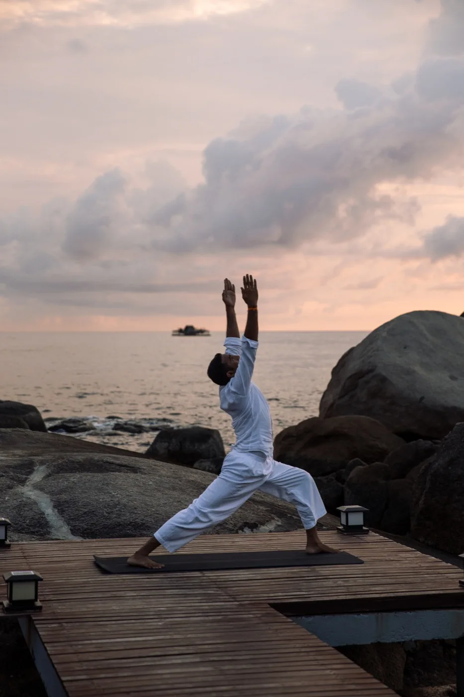Yoga on a seaside deck at sunset at Banyan Tree Bintan