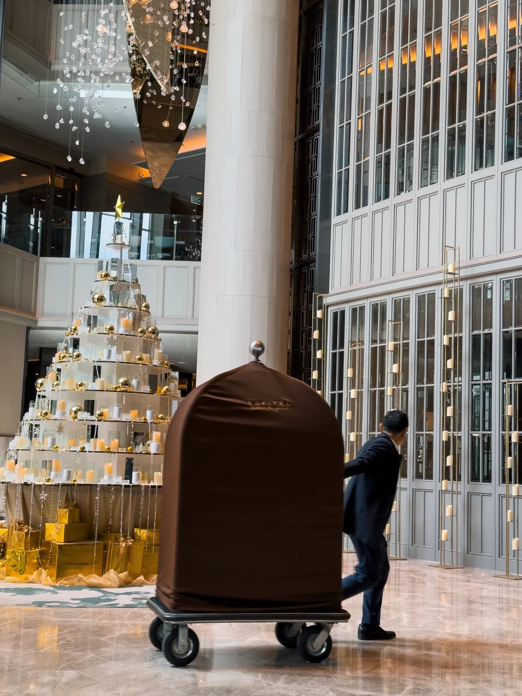 Bellman with a luggage trolley in the lobby of Sofitel Bangkok