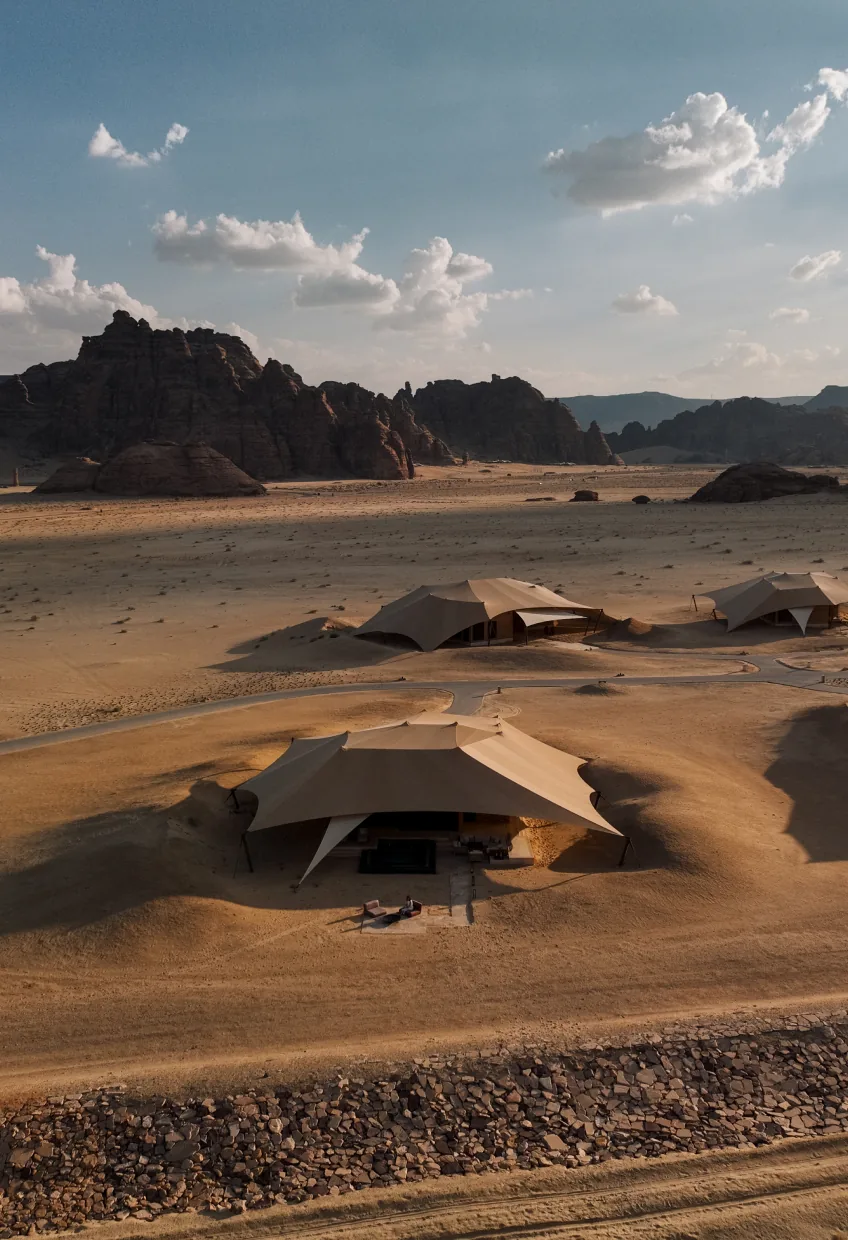 Aerial view of tented villas among desert rock formations at Banyan Tree AlUla