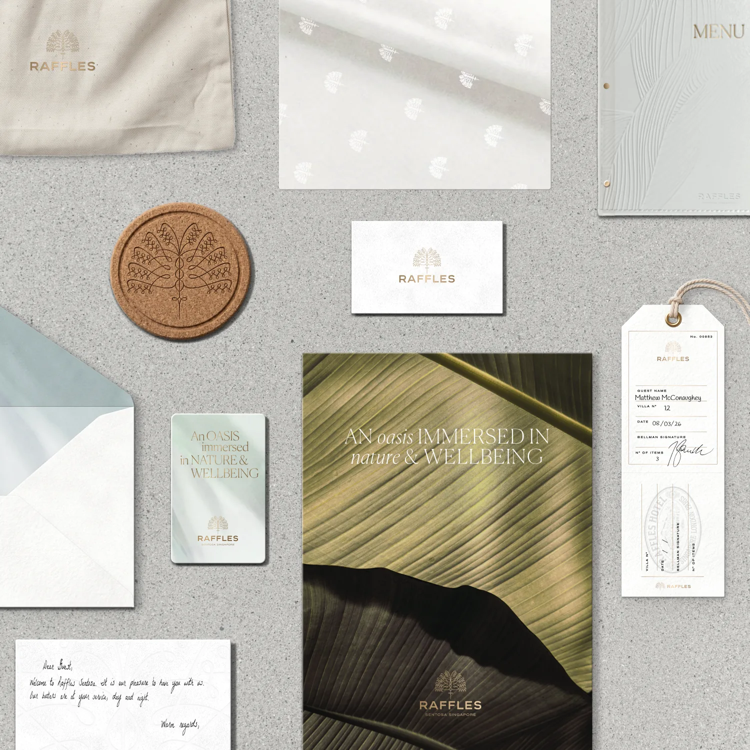 Raffles hotel collateral flatlay: menu, cards, coaster, envelope, luggage tag and brochure