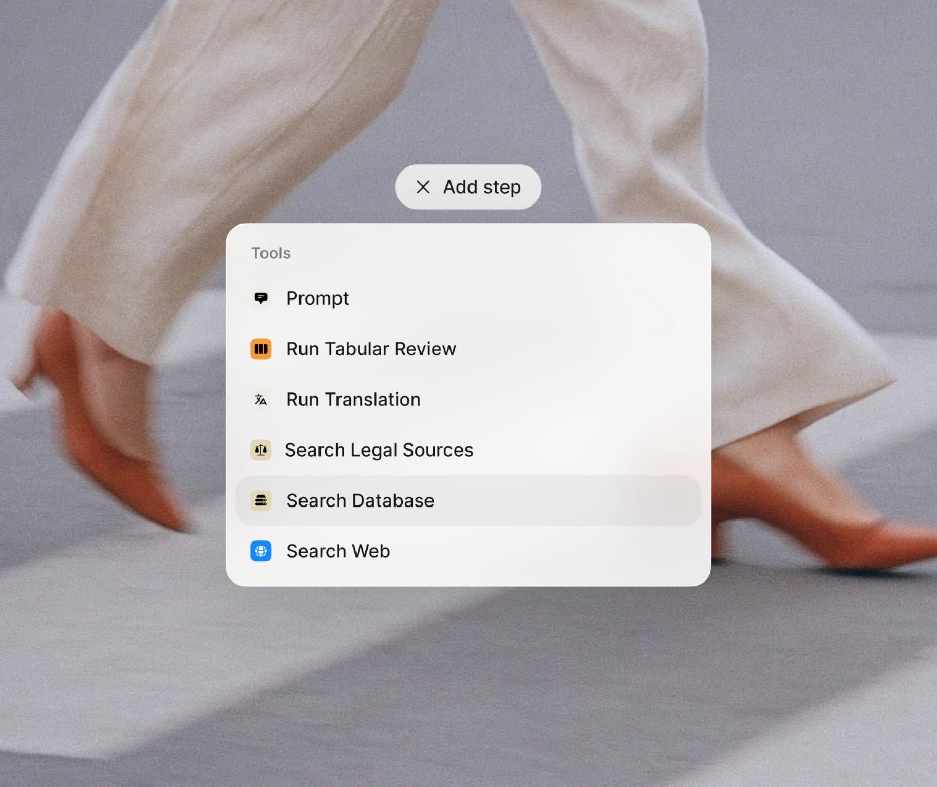 Legora UI showing the “Add step” tool menu with database and legal search options, layered over a modern lifestyle image that reflects the brand’s balance of movement, precision, and design clarity