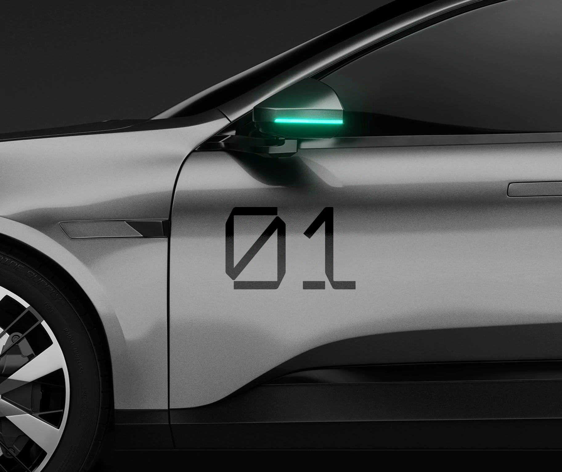 Airon numeral 01 in the custom chamfered typeface applied to the door of a silver electric car.