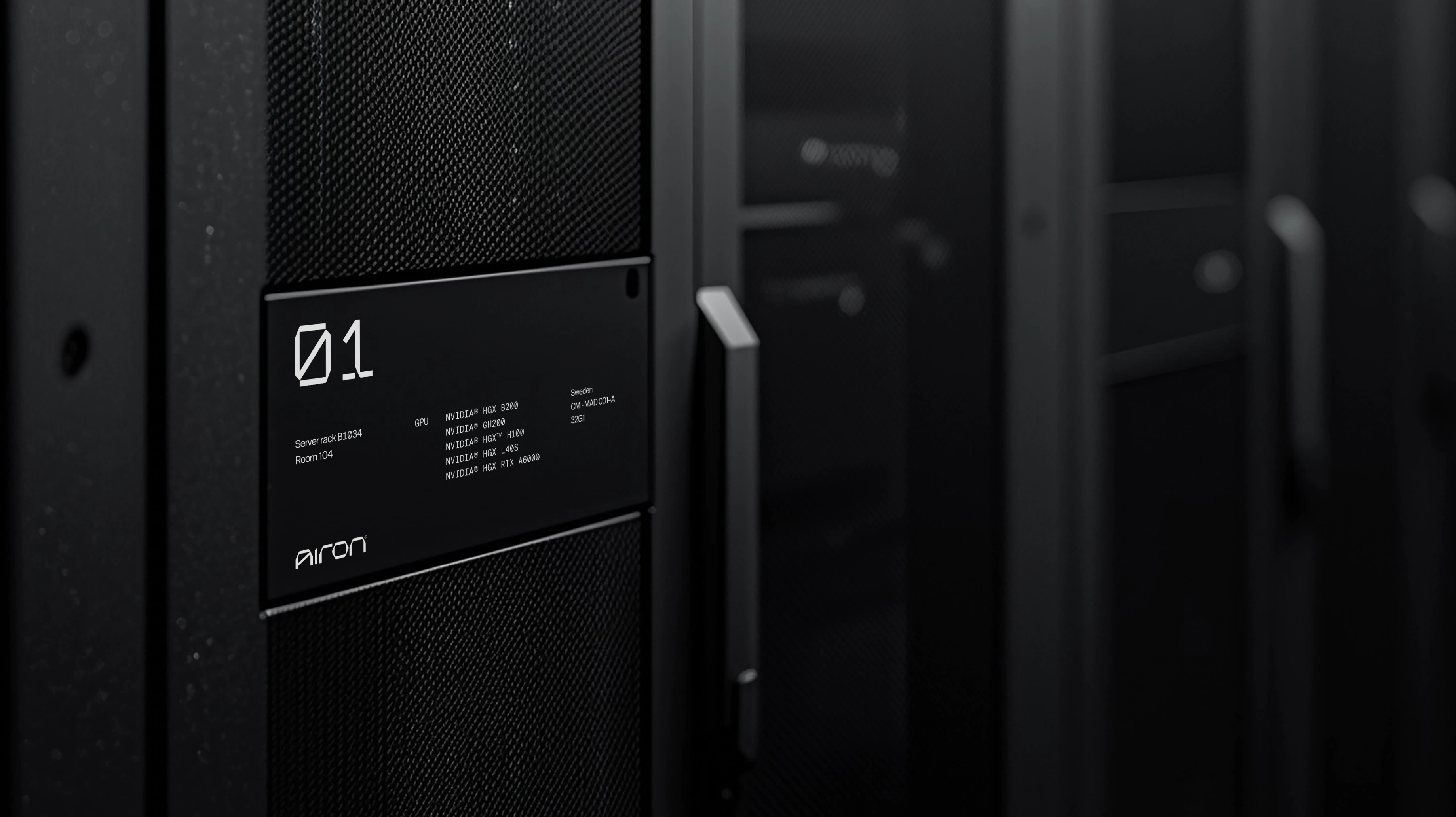 Airon-branded label plate marked 01 on a black server rack in a dark data centre aisle.