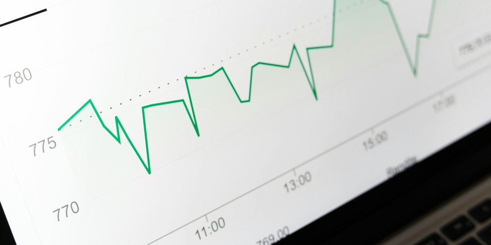 Close-up of a green line chart on a laptop screen
