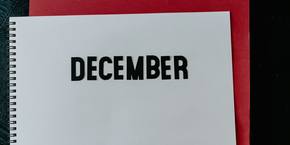 Spiral notebook page with the word December in black letters