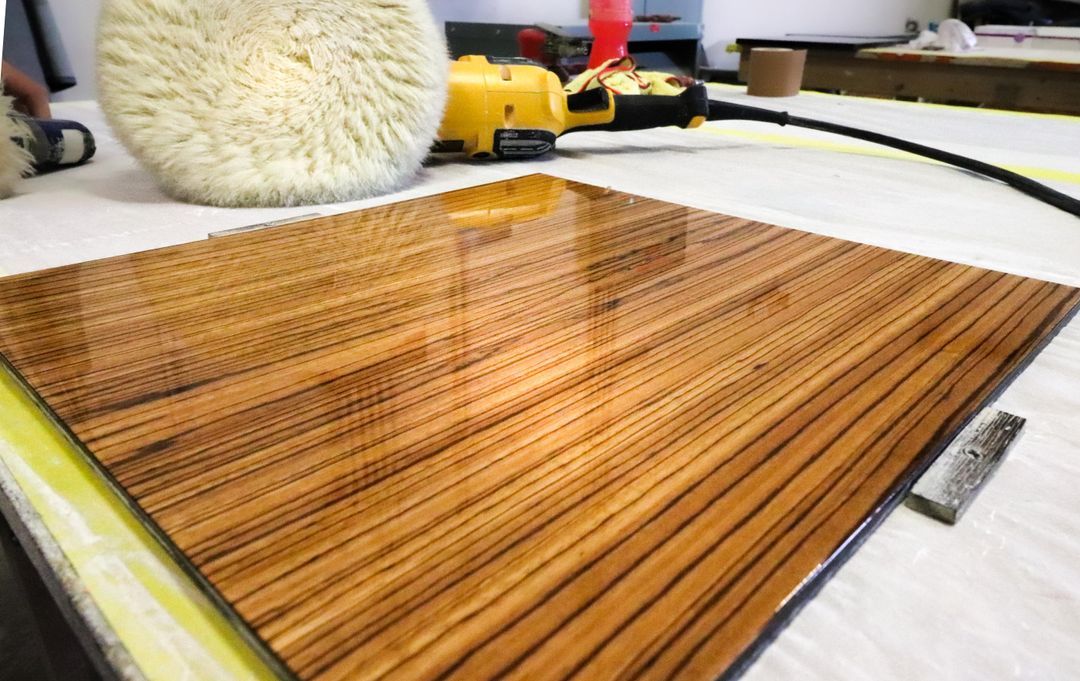 Polished zebrawood veneer panel being buffed