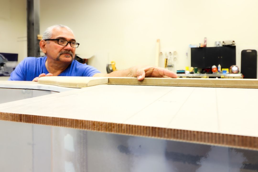 Master cabinetmaker checking a veneer panel
