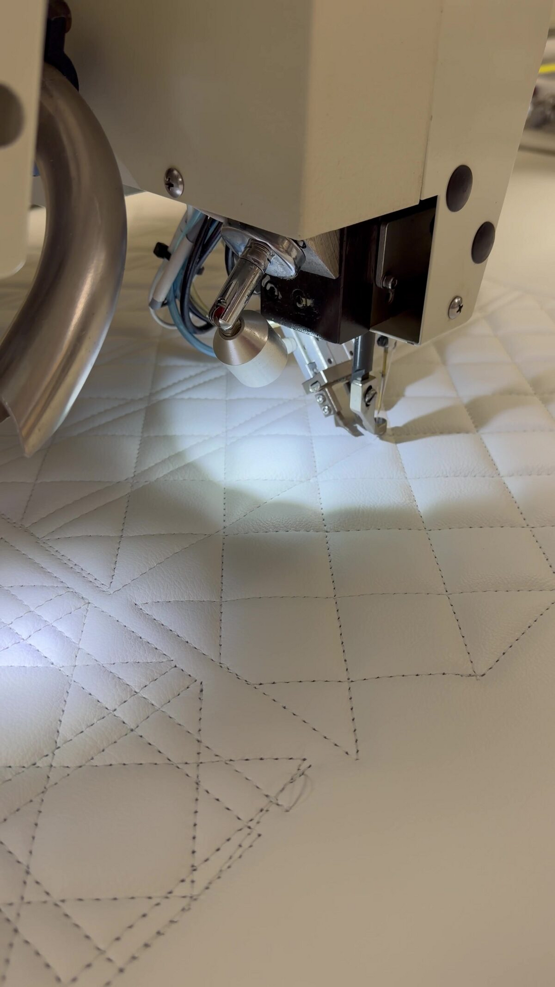 Programmed stitch pattern in progress on the CNC upholstery machine