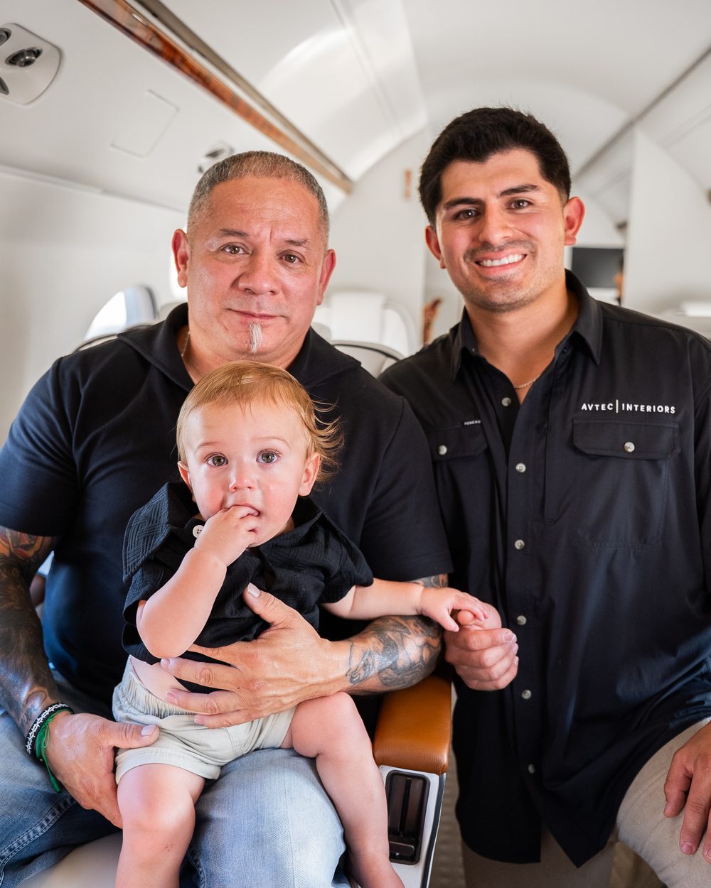 Three generations of the Guzman family inside a refurbished business jet cabin