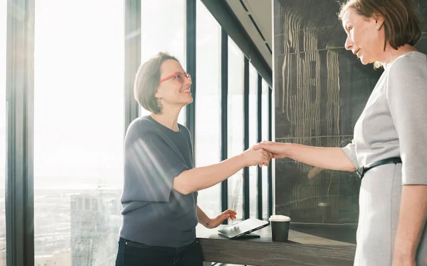 Young female is presented to a group of people at work