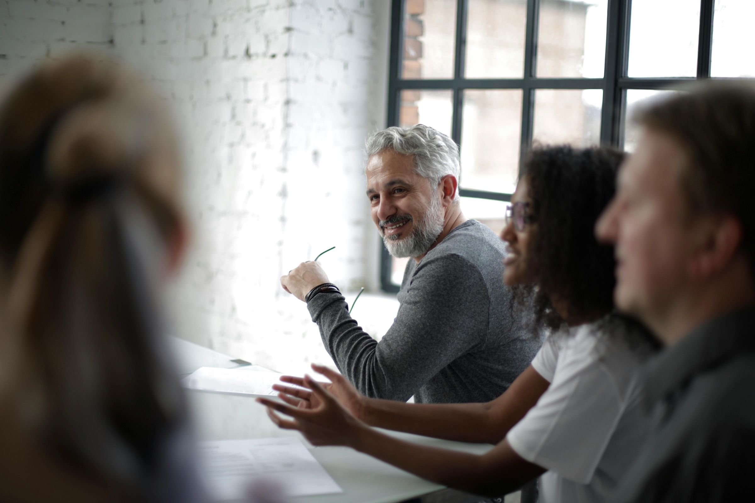 Young female is presented to a group of people at work