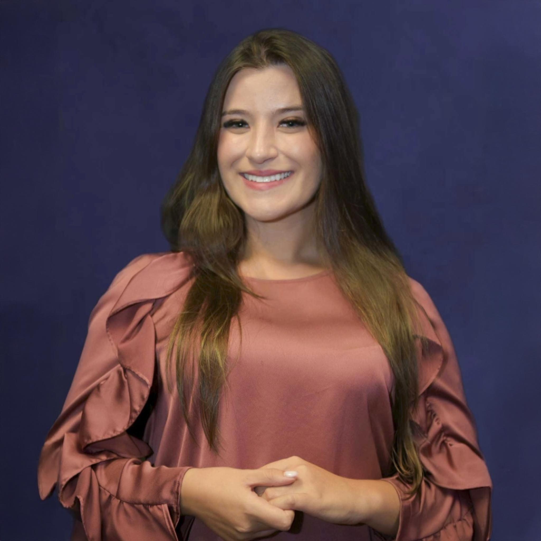 Nicoly smiling towards the camera.