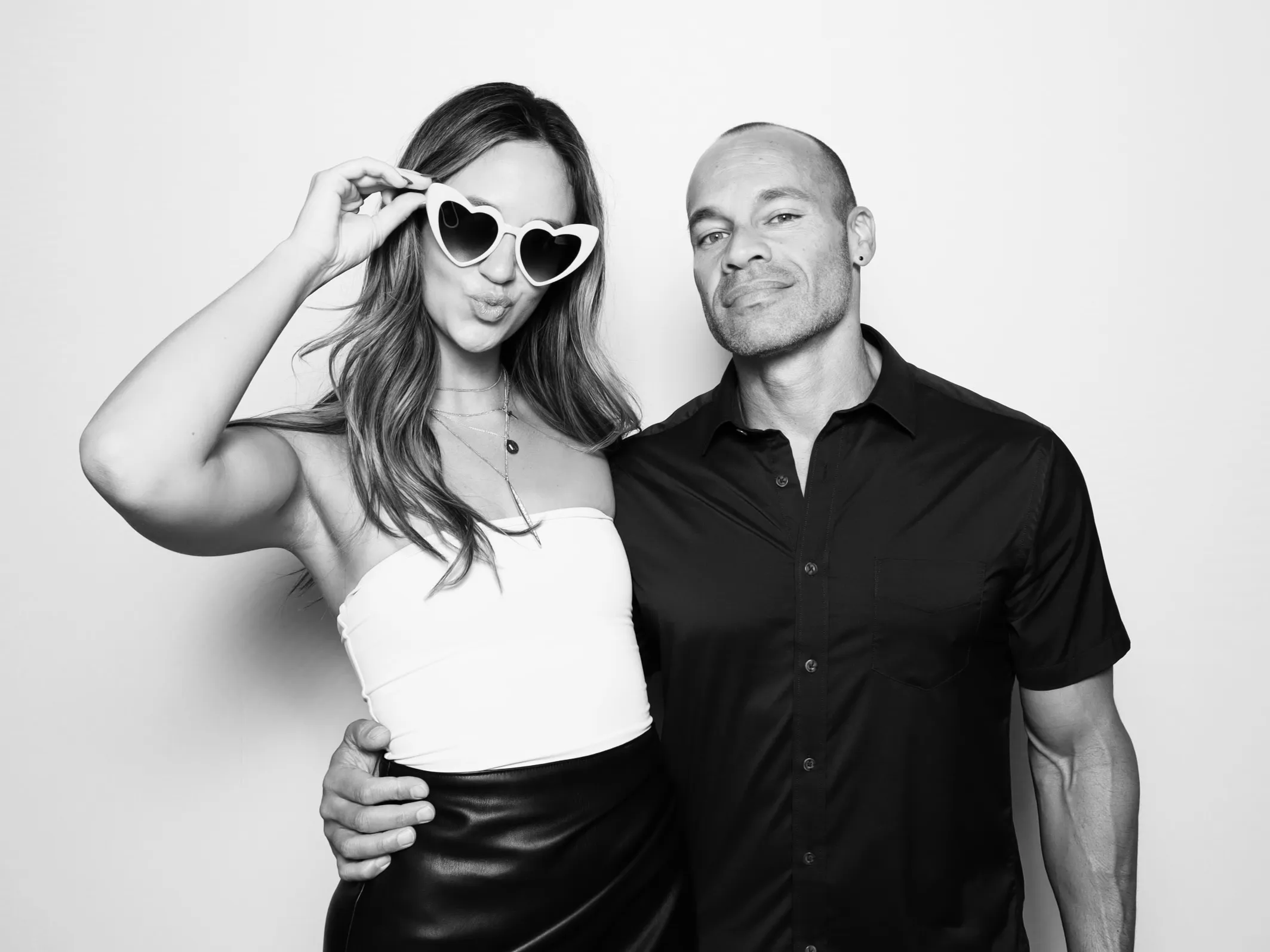 Glam photo booth rental. Couple posing for Palace Aesthetics Grand Opening in Portland.