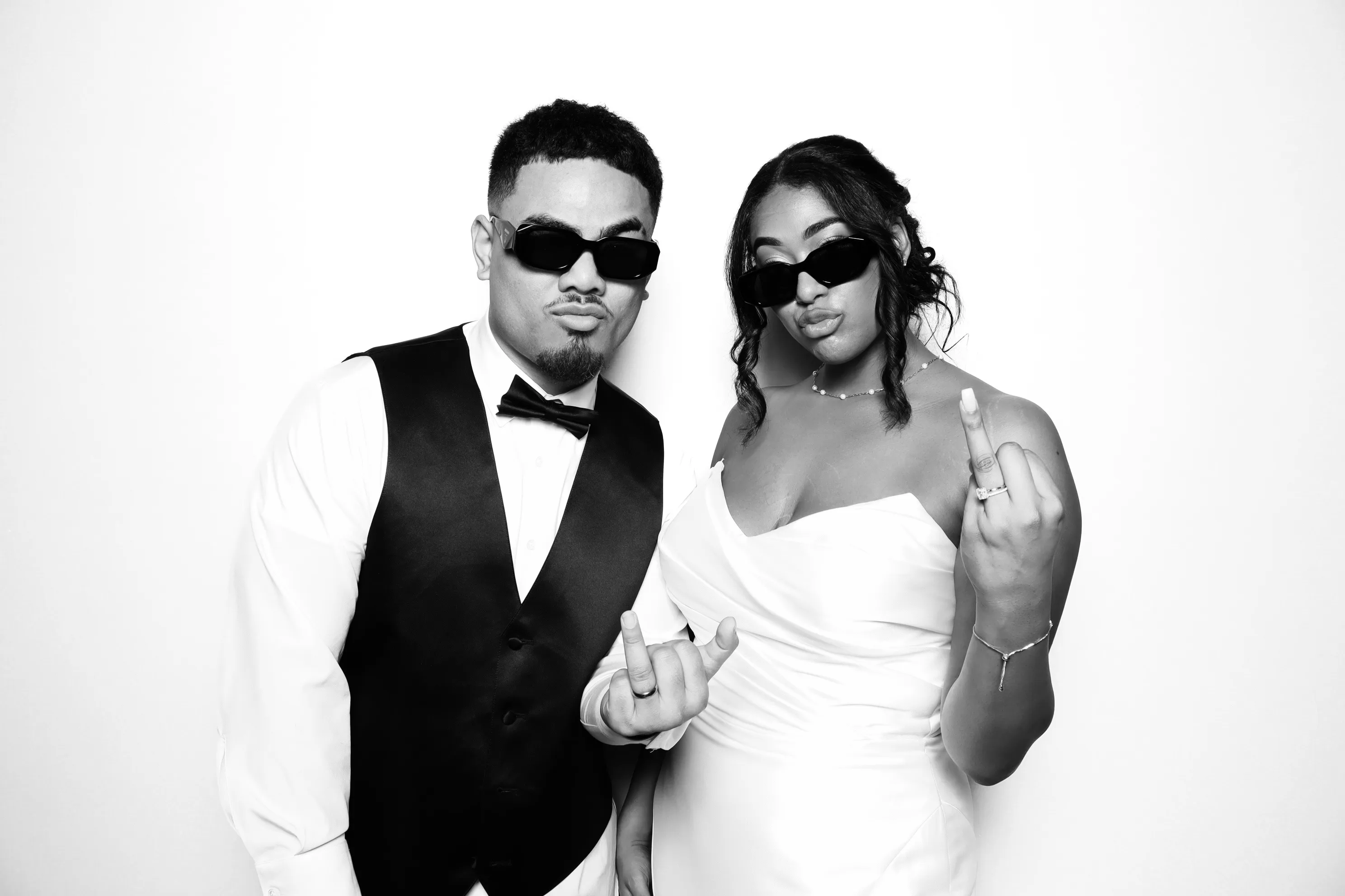 Glam photo booth rental with stylish couple in sunglasses posing