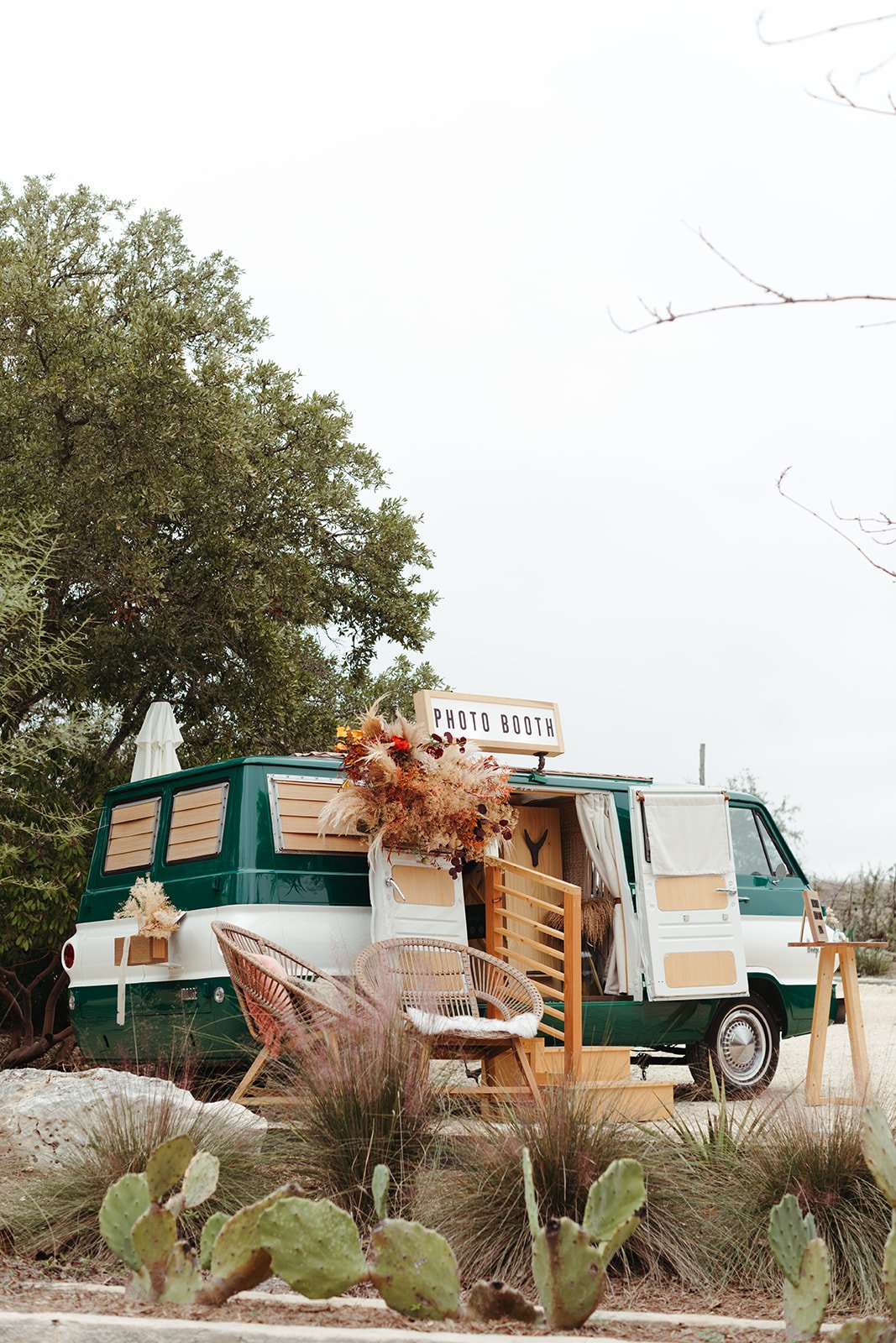 Vintage green and white photo booth rental van with rustic desert backdrop