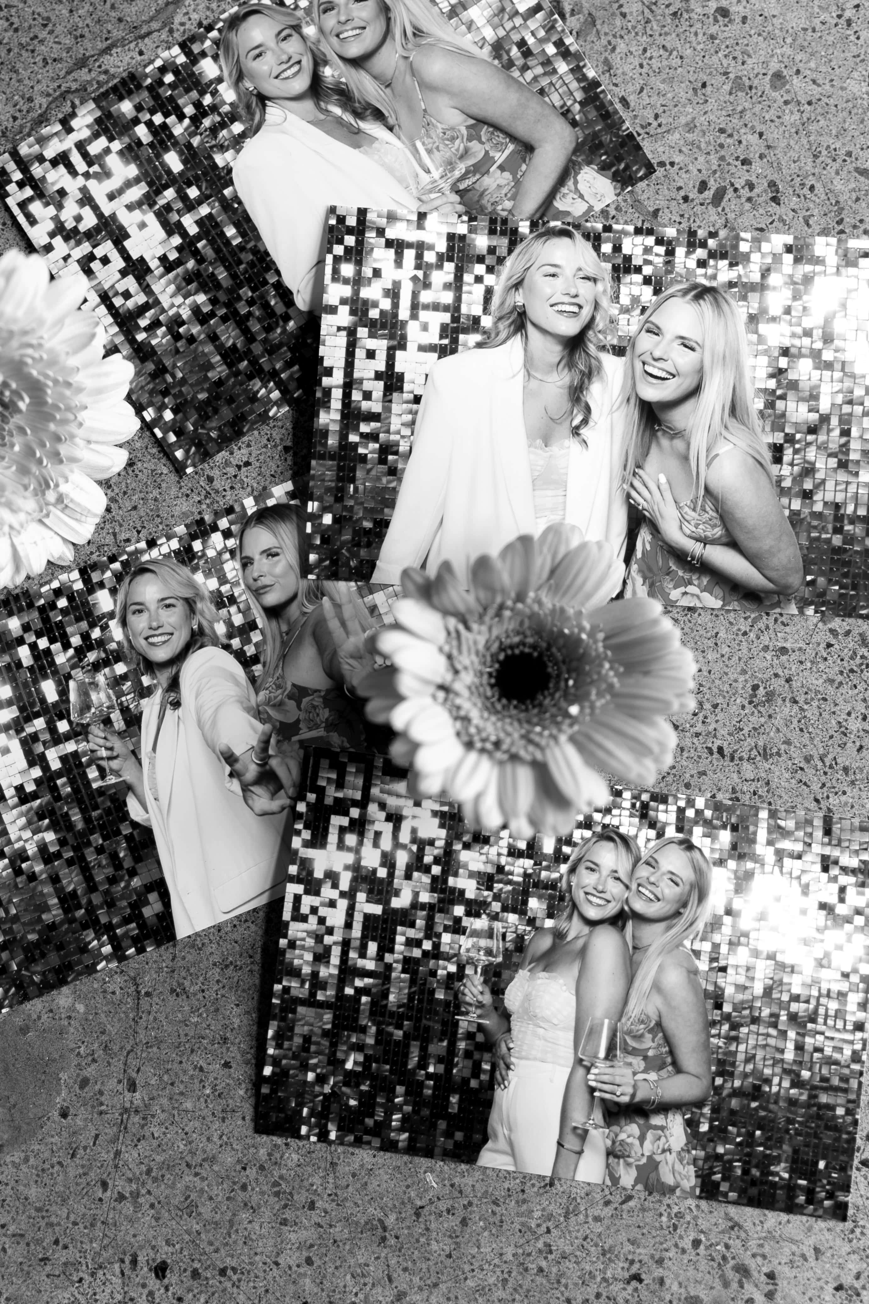 Collage of three black-and-white photo booth pictures showing two smiling women posing together against a shiny sequin backdrop, with a flower in the foreground.