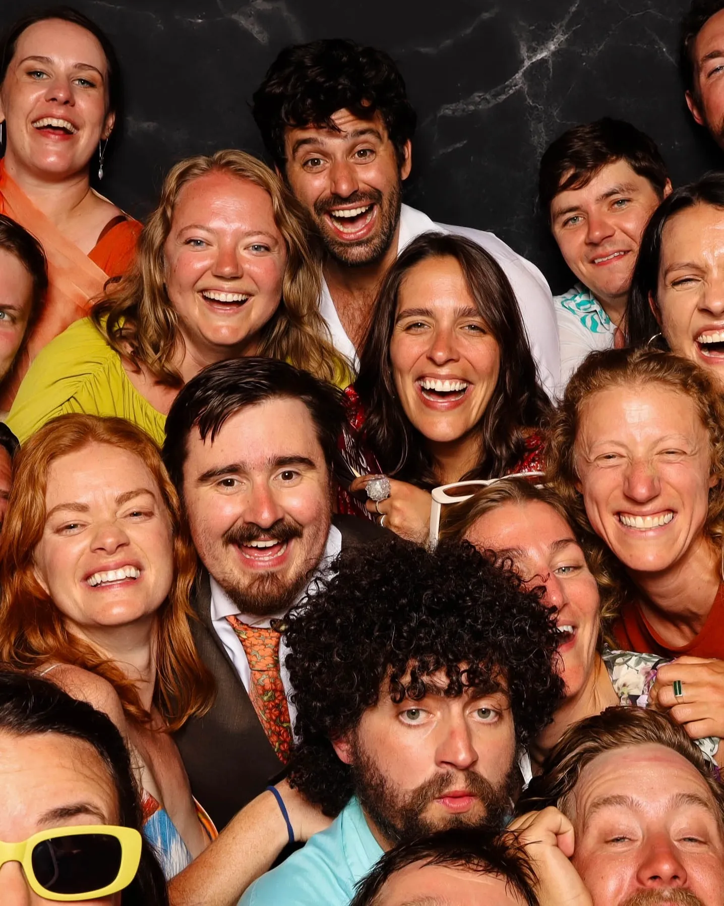 Group of friends laughing together at open-air photo booth rental in Portland Oregon