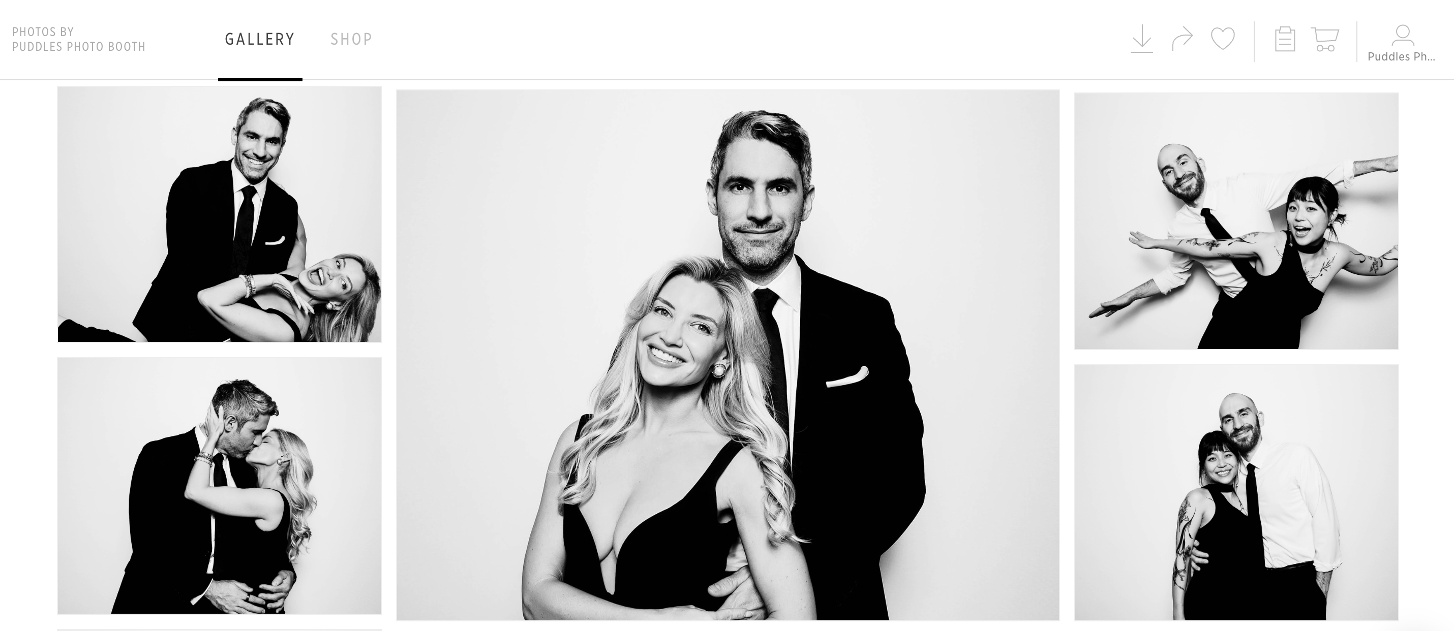 White photo booth with umbrella light in front of a reflective mosaic backdrop, surrounded by green potted plants on a polished concrete floor.
