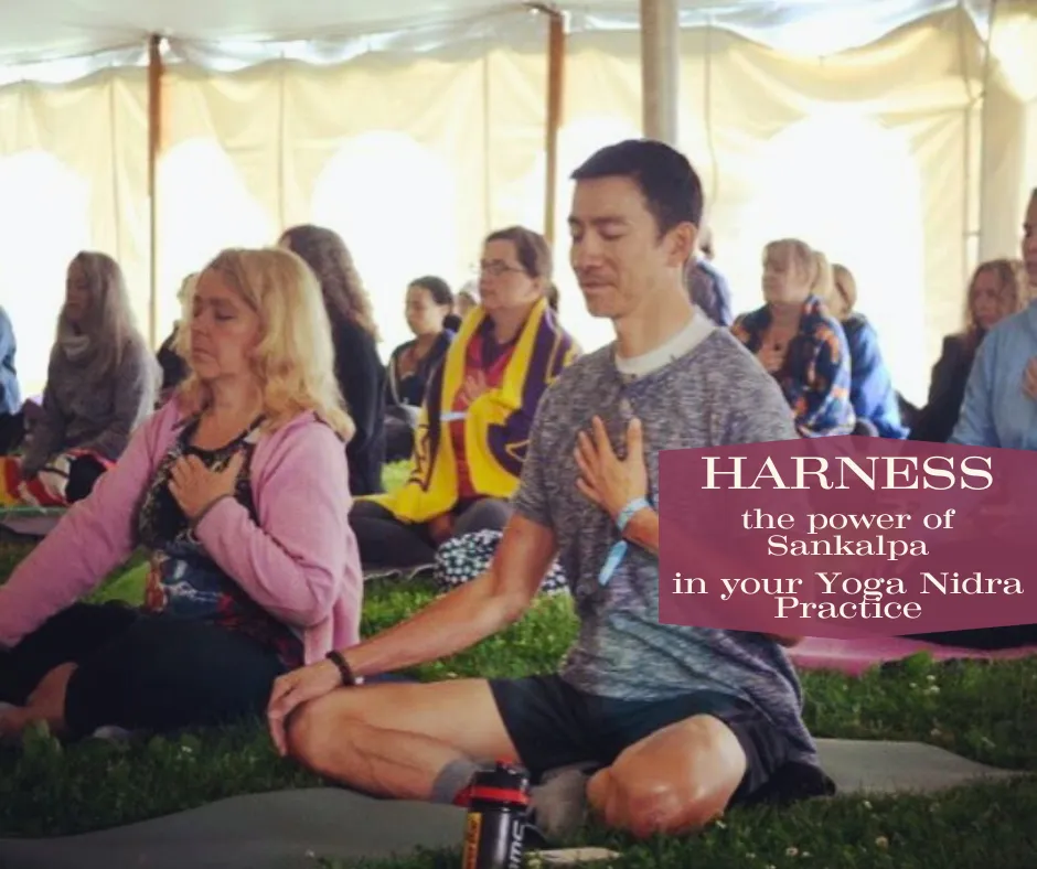 a picture of two people sitting on yoga mats meditating with their hands on their hearts