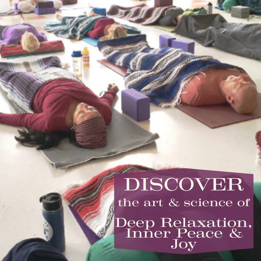 a photo of yoga students laying on yoga mats in savasana