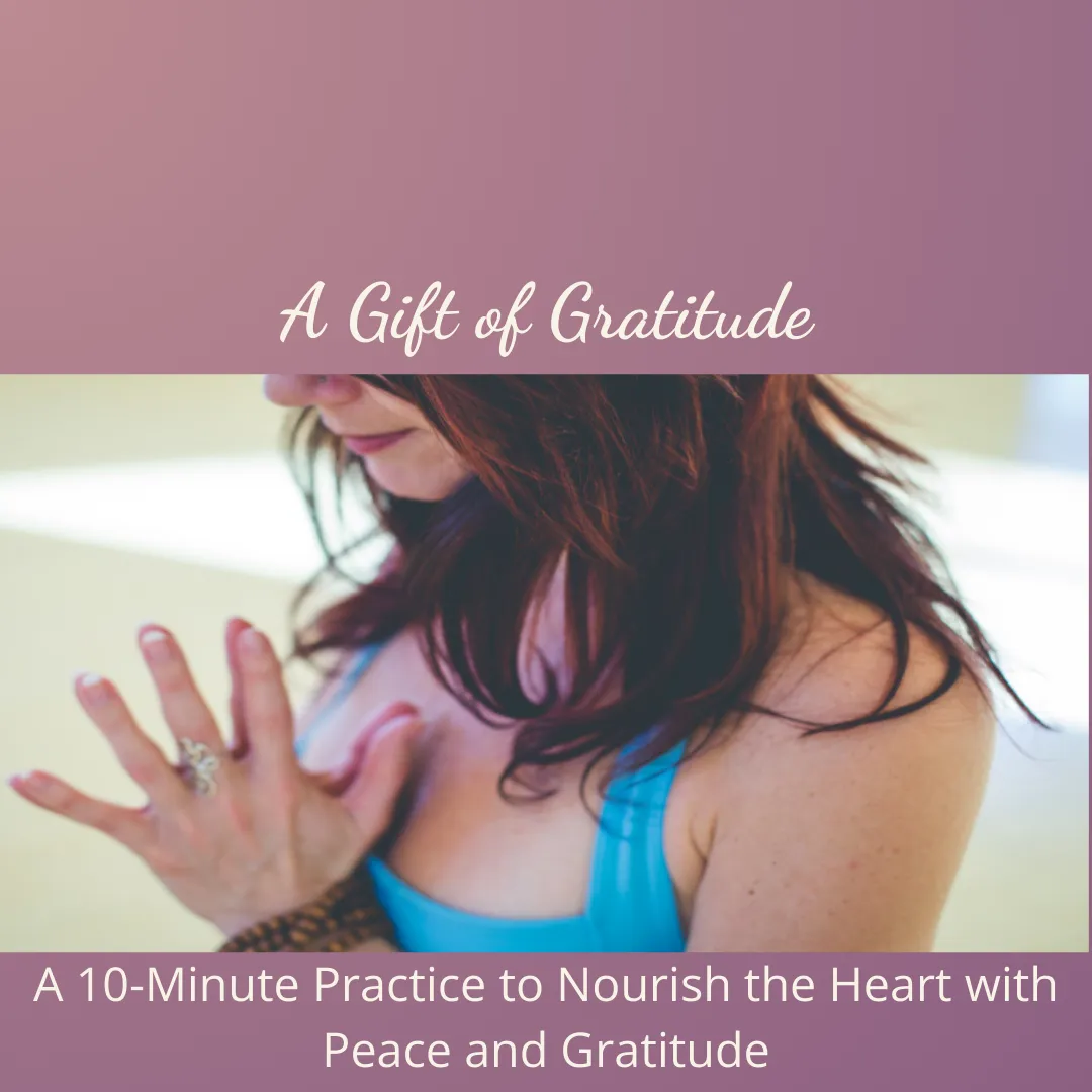 a female holding her hands in prayer position in front of her heart