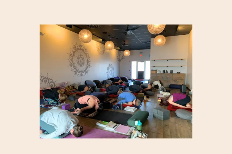 a yin yoga class doing child's pose