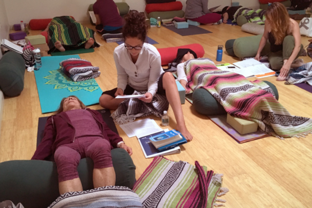 Students practicing Yoga Nidra during a Yoga Nidra teacher training with Sagel Urlacher