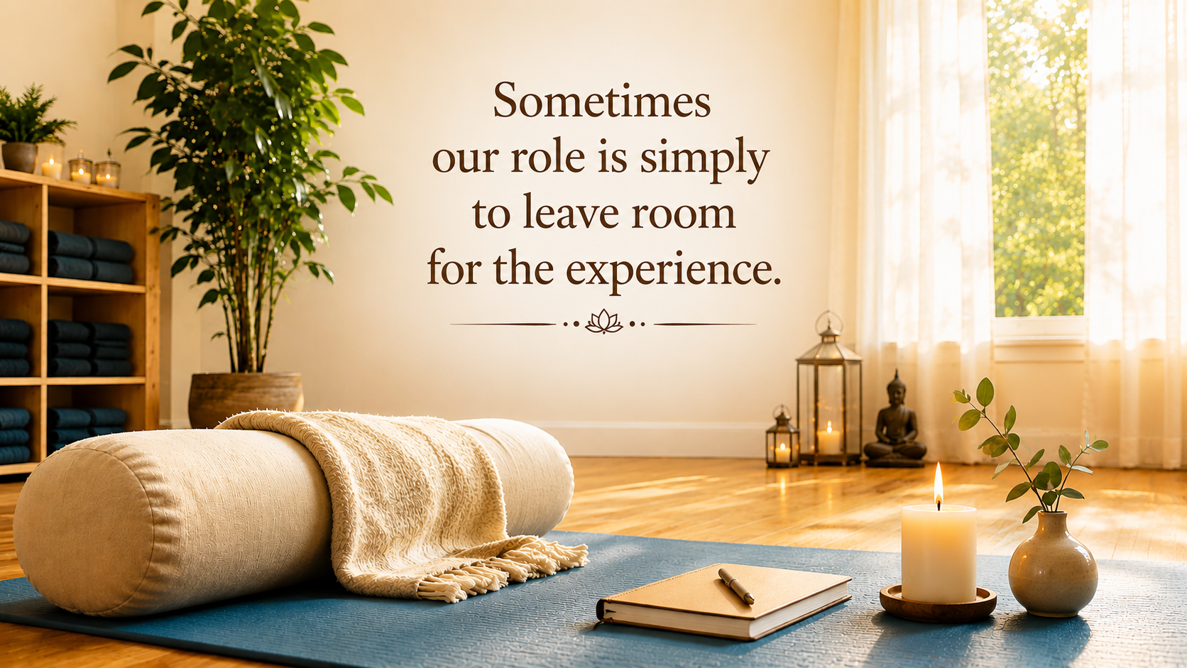 https://Yoga Nidra practice space with bolster, mat, and candle featuring the words “Sometimes our role is simply to leave room for the experience.”