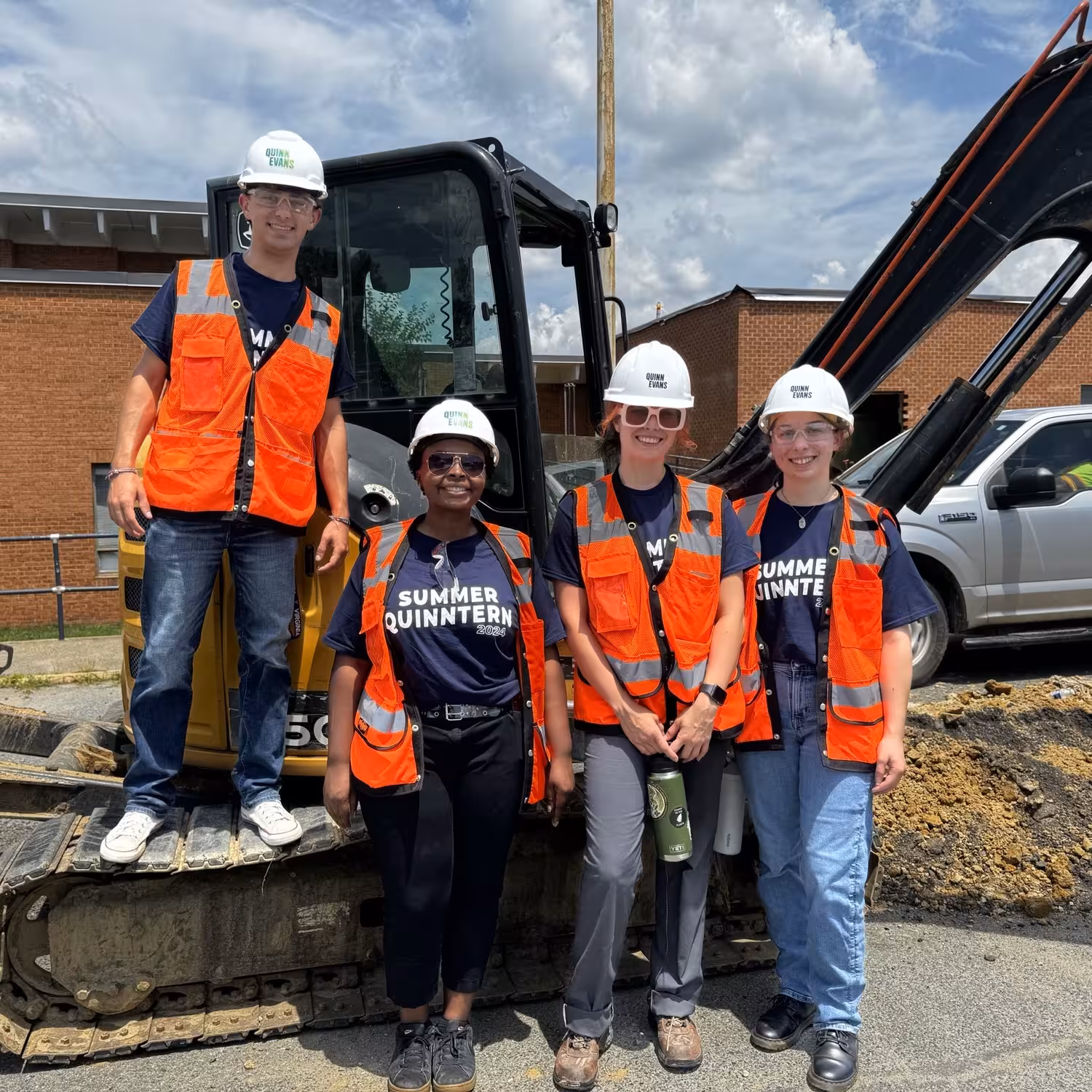 Four summer interns visit a construction site.