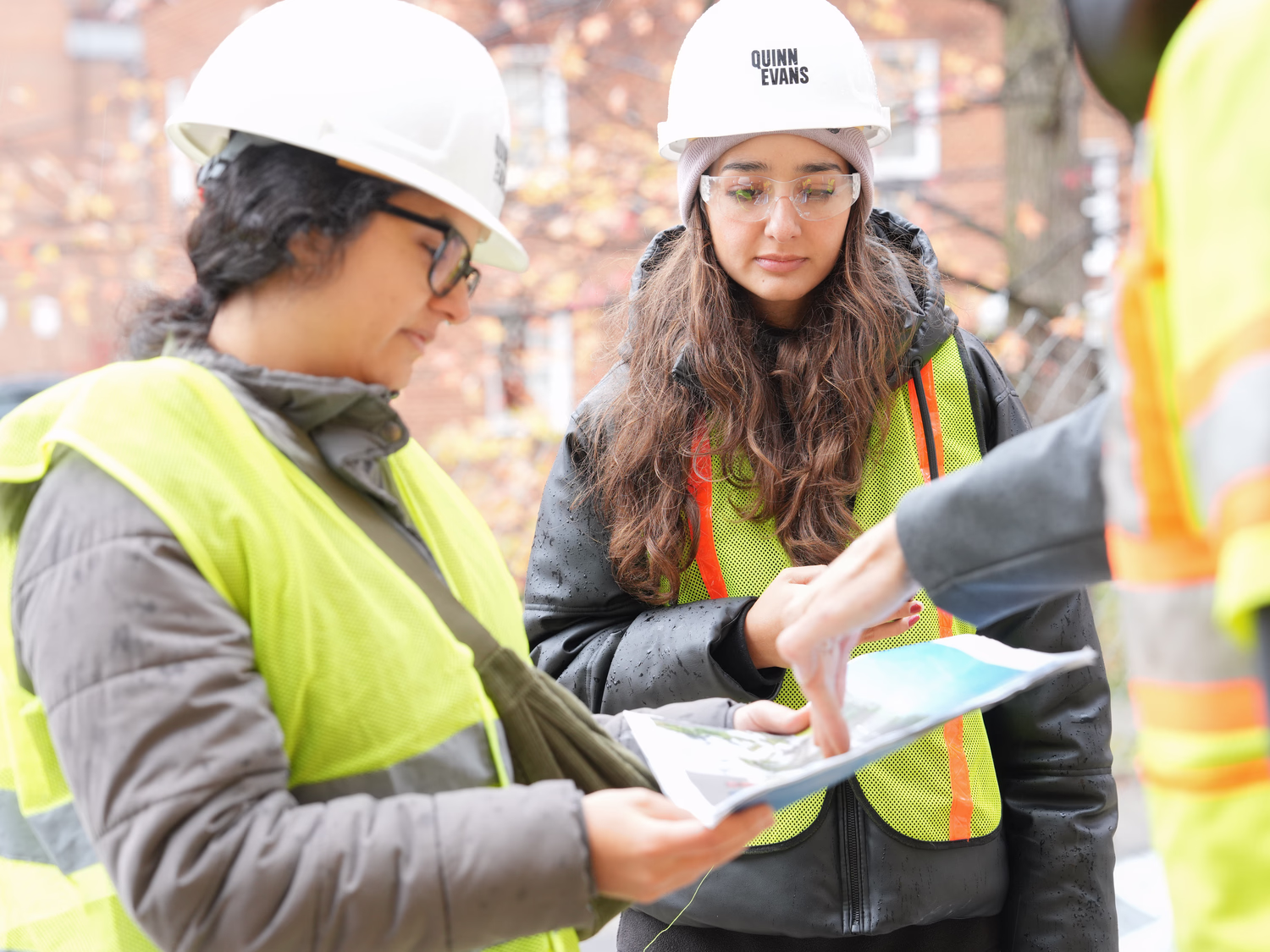 Team members discuss a project on site.