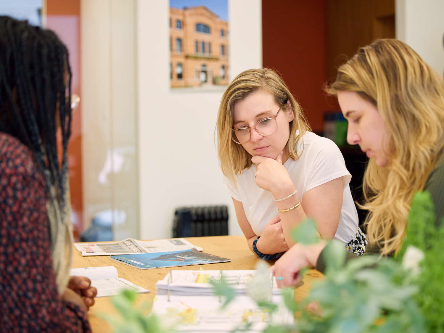 Three team members listen to each other.