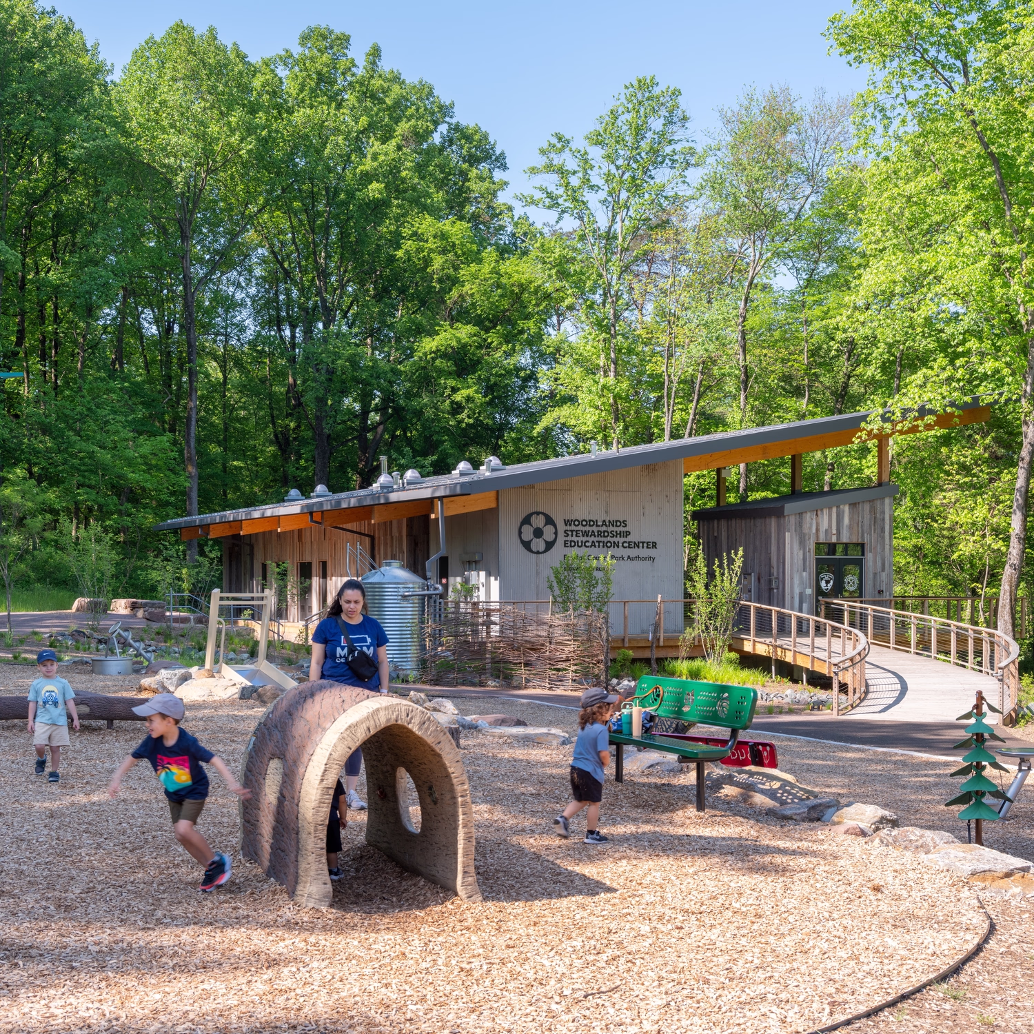 Children play in front of the Woodlands Stewardship Education Center.