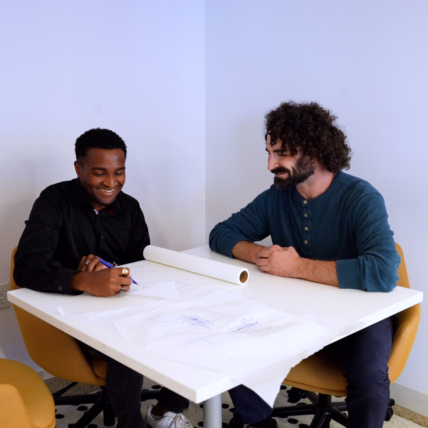 Two colleagues collaborate on a design.
